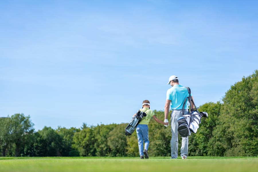 parent & child golfing together