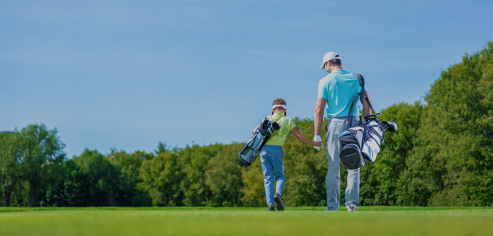 dad and son with golf bags