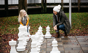 mom and daughter playing chess